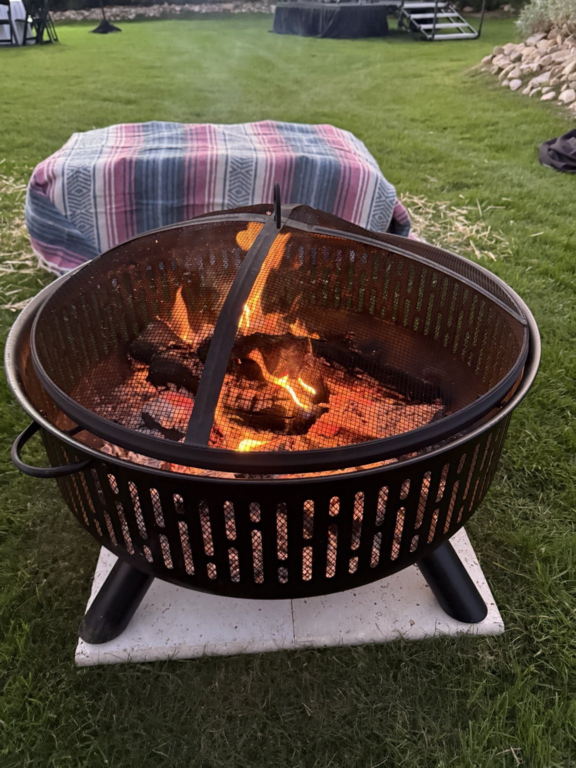 Fire pit with blanket covered seating