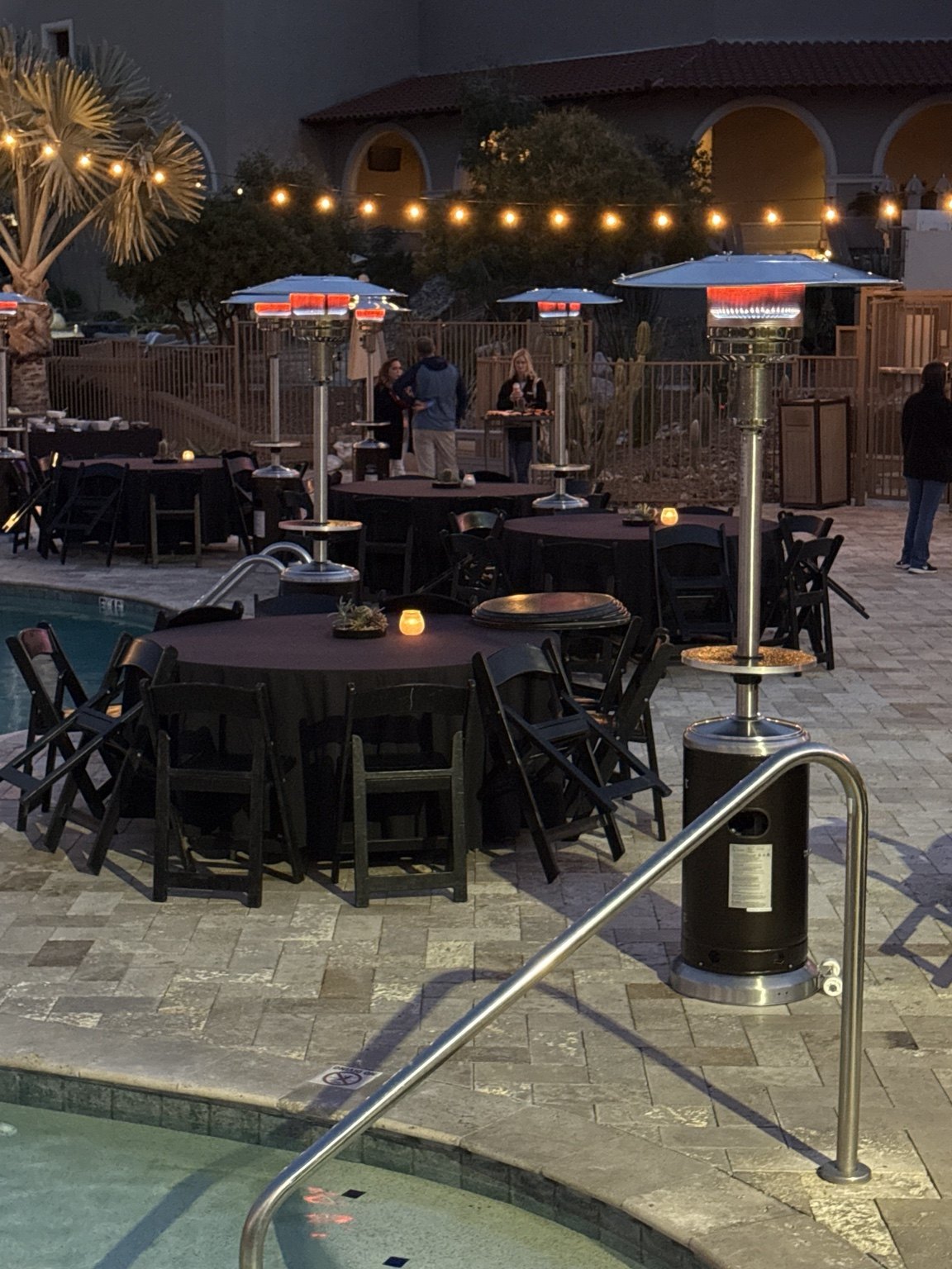 Patio heaters arranged around outdoor event tables