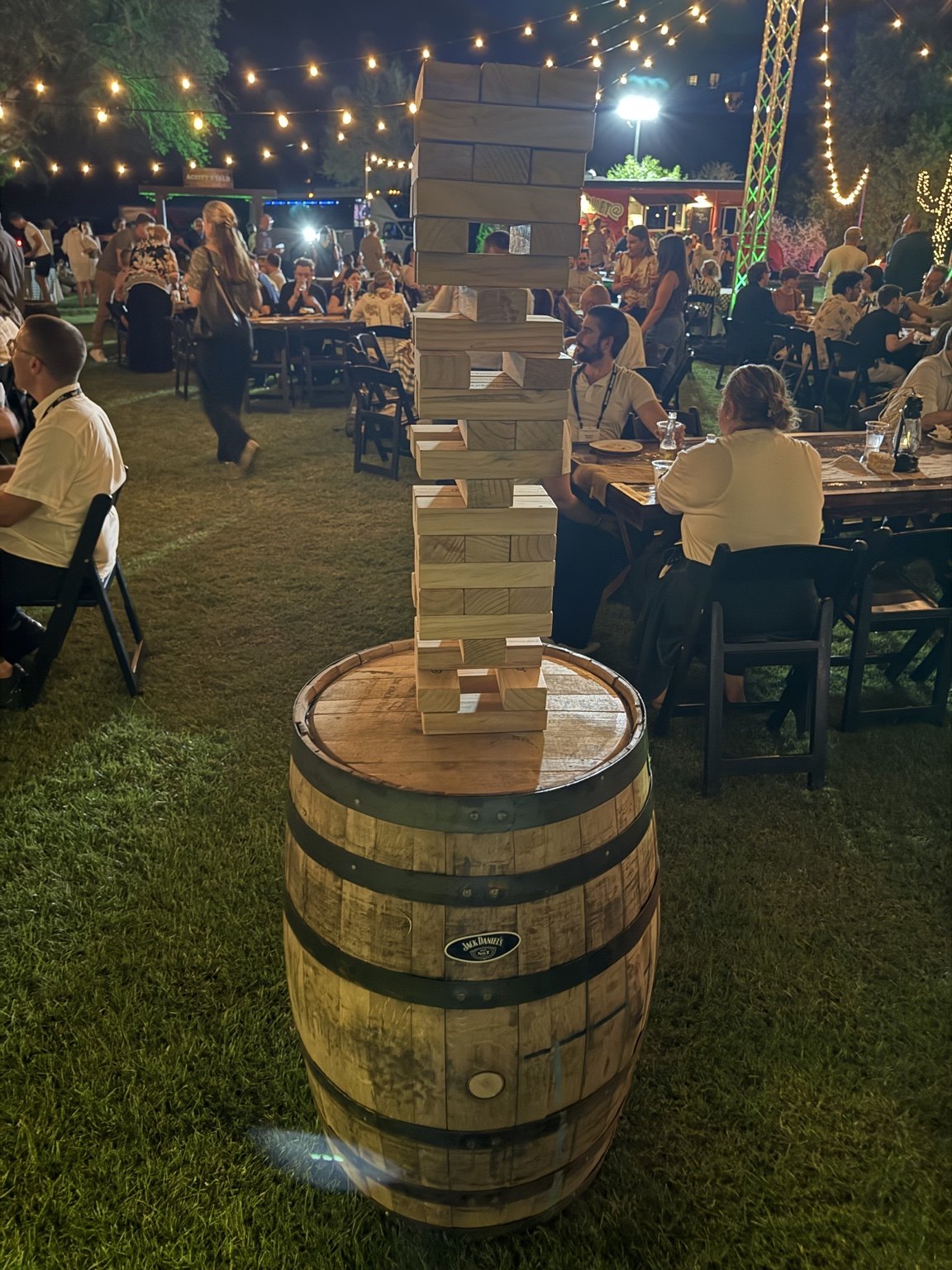 Giant Jenga on a whiskey barrel at an evening event